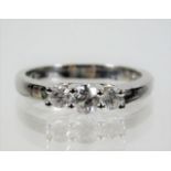 An 18ct white gold ring set with three diamonds of