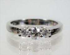 An 18ct white gold ring set with three diamonds of