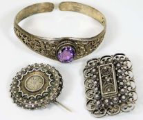 A decorative silver bangle set with amethyst style
