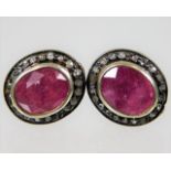 A pair of 9ct gold & silver earrings set with ruby