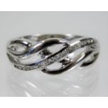 A 9ct white gold celtic style ring set with diamon