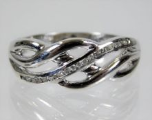 A 9ct white gold celtic style ring set with diamon