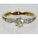 A Victorian yellow metal ring, tests as 14ct gold, set with approx. 0.55ct centre stone & three diam