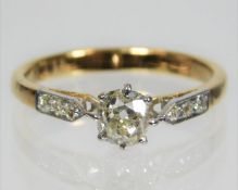 A Victorian yellow metal ring, tests as 14ct gold, set with approx. 0.55ct centre stone & three diam