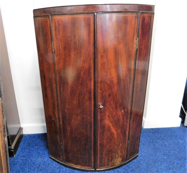 A 19thC. mahogany cylindrical corner cabinet