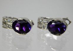 A pair of 18ct gold earrings set with amethyst & white stones 4g
