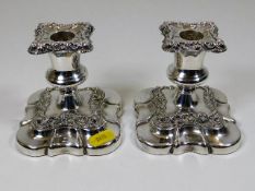 A pair of decorative silver plated candleholders
