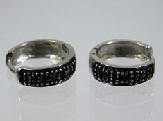 A pair of 9ct white gold earrings set with black &
