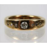An 18ct gold ring set with diamonds, centre stone