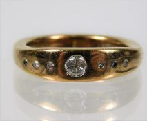 An 18ct gold ring set with diamonds, centre stone