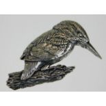 A white metal kingfisher pin brooch with script in