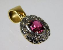 A 14ct gold pendant set with diamond & ruby 1.7g