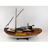 A wooden model boat & stand 26in long x 18in high