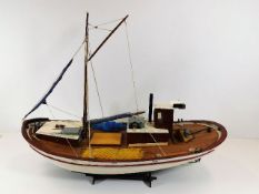 A wooden model boat & stand 26in long x 18in high