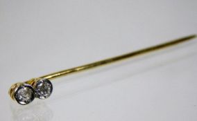 A yellow metal tie pin set with two diamonds 1.3g
