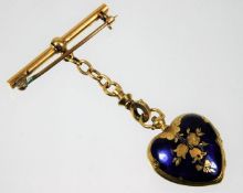 A yellow metal brooch & enamelled locket with chain, tests as 18ct gold, 8.9g