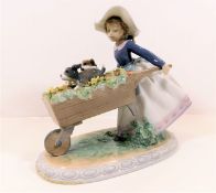 A Lladro figurine of girl with wheelbarrow & puppi