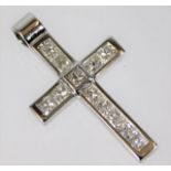 An 18ct white gold cross set with approx. 1ct diam