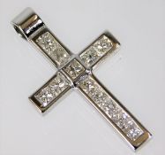 An 18ct white gold cross set with approx. 1ct diam