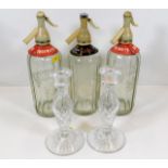 Three vintage soda syphons twinned with a pair of