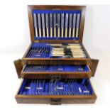 A three tier oak cased canteen of cutlery, some ma