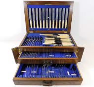 A three tier oak cased canteen of cutlery, some ma