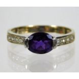 An 18ct gold ring set with amethyst & white stones