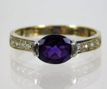 An 18ct gold ring set with amethyst & white stones
