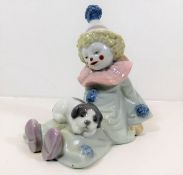 A Lladro clown figurine seated with puppy pattern