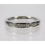 An 18ct white gold ring half eternity ring set wit