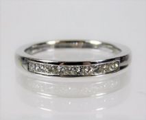 An 18ct white gold ring half eternity ring set wit