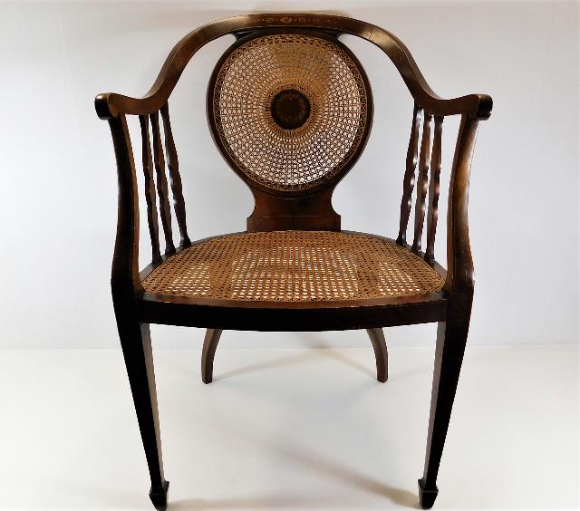 An Edwardian cane chair with inlaid centre & top