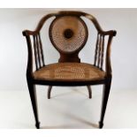 An Edwardian cane chair with inlaid centre & top