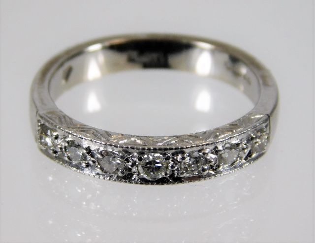 A platinum half eternity style ring set with seven diamonds, approx. 0.21ct 5g size L/M