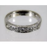 A platinum half eternity style ring set with seven diamonds, approx. 0.21ct 5g size L/M