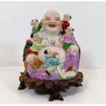 An early 20thC. porcelain laughing Buddha with sta