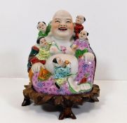 An early 20thC. porcelain laughing Buddha with sta