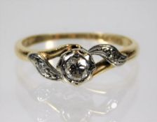 An 18ct gold ring set with diamonds, centre stone