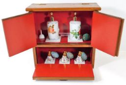 A shop display perfume cabinet with Limoges porcel