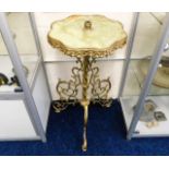 A brass & onyx pedestal table