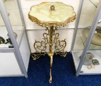 A brass & onyx pedestal table