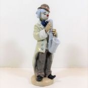 A Lladro clown figurine with saxophone pattern no.