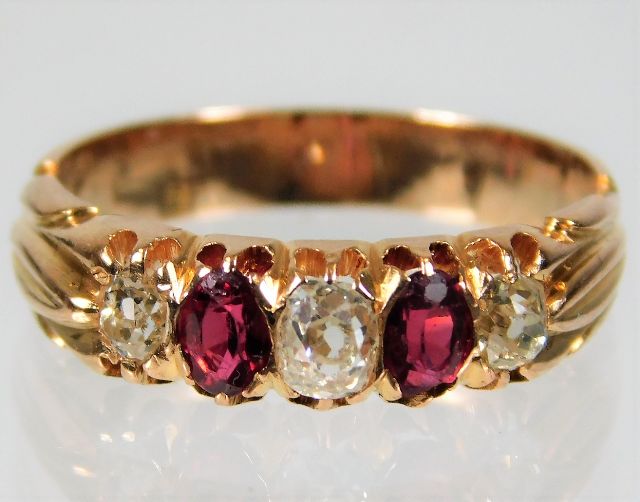 A yellow metal Victorian ring, tests as 18ct gold, set with approx. 0.45ct diamond & ruby 4.1g size