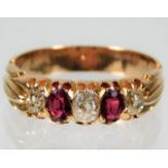 A yellow metal Victorian ring, tests as 18ct gold, set with approx. 0.45ct diamond & ruby 4.1g size