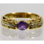 An 18ct gold ring set with amethyst with six diamo