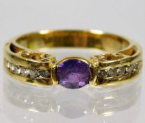 An 18ct gold ring set with amethyst with six diamo