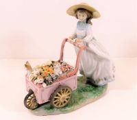 A Lladro figurine of girl with wheelbarrow & kitte