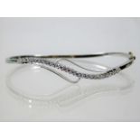 An 18ct white gold bangle set with approx. 0.9ct d