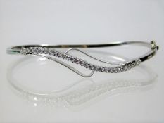 An 18ct white gold bangle set with approx. 0.9ct d