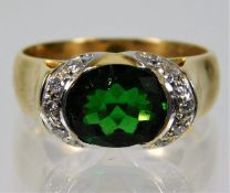 An 18ct gold ring set with tourmaline & diamond 9.